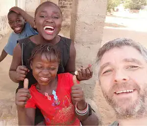 Roger with local kids in Tanzania